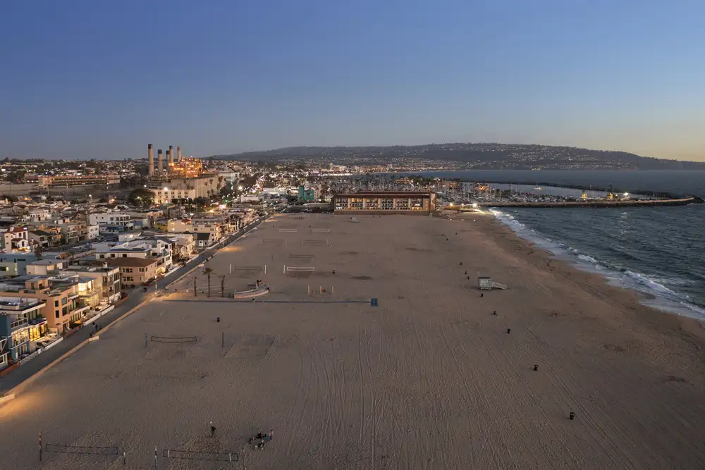 Aerial view of Hermosa Beach coastline and cityscape at sunset