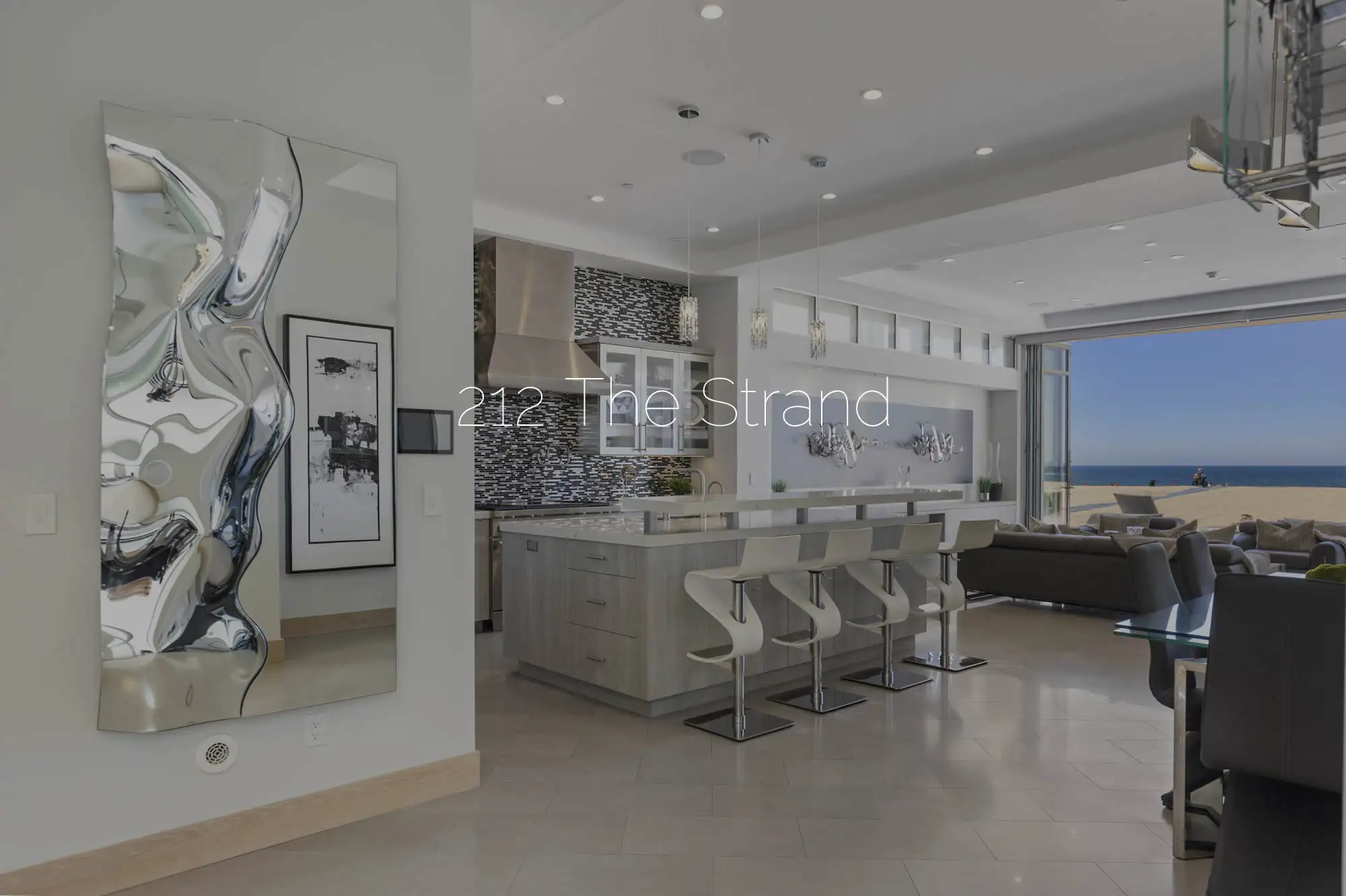 Modern beachfront kitchen and living area at 212 The Strand, showcased by Patricia Blakemore Real Estate