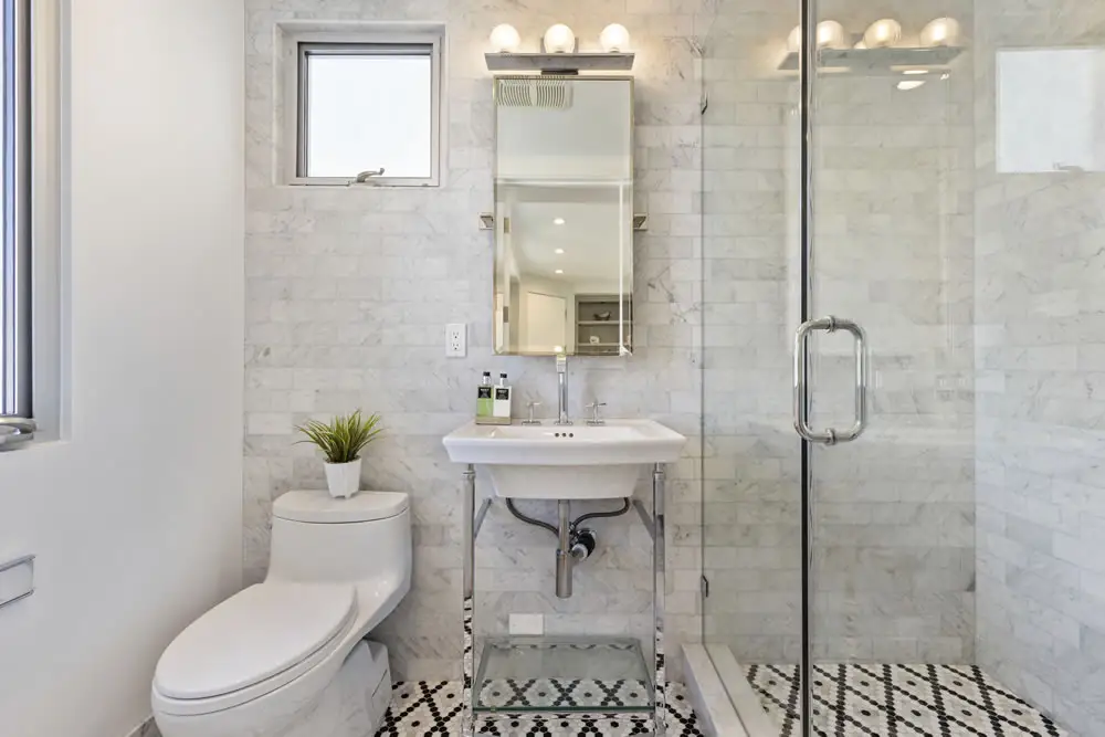 Elegant office bathroom with glass shower and modern design at 212 The Strand